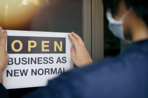 Sign showing a woman getting ready to re-open her business