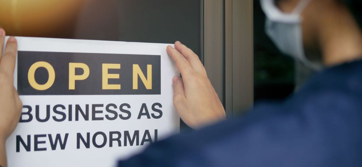 Sign showing a woman getting ready to re-open her business