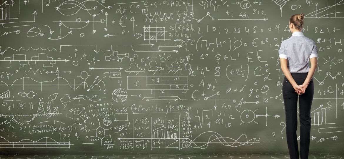 woman examining blackboard