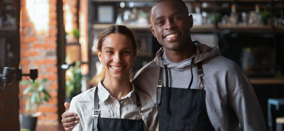 Happy,Diverse,Waiter,And,Waitress,Looking,At,Camera,,Smiling,African