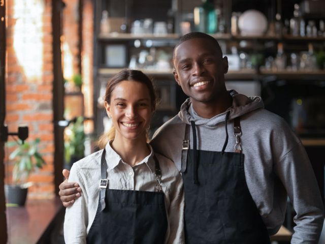 Happy,Diverse,Waiter,And,Waitress,Looking,At,Camera,,Smiling,African