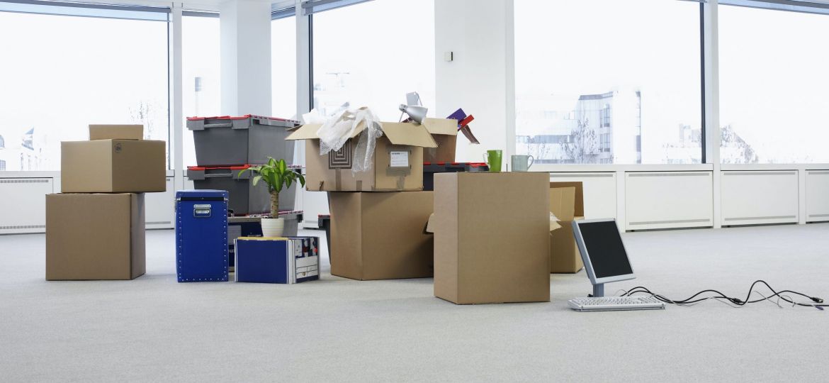 Cartons and equipment on floor of empty office space