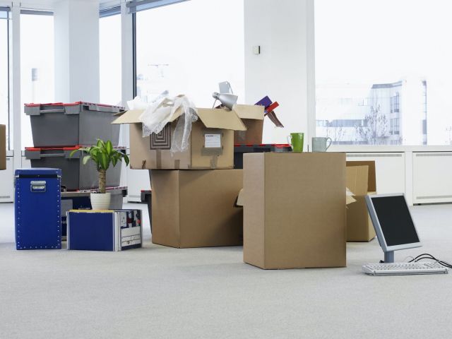 Cartons and equipment on floor of empty office space