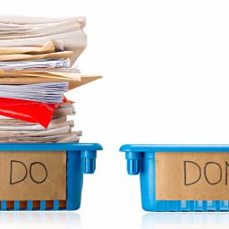 Procrastination - A full To Do tray and an empty Done tray - Overwhelmed - Isolated on white background