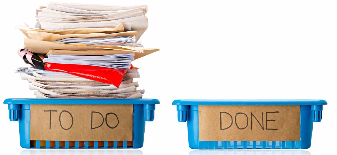 Procrastination - A full To Do tray and an empty Done tray - Overwhelmed - Isolated on white background
