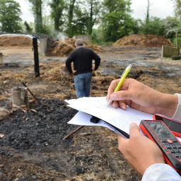 People looking at burned out home