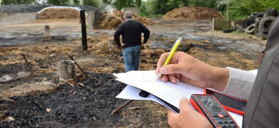 People looking at burned out home