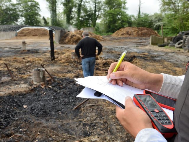 People looking at burned out home