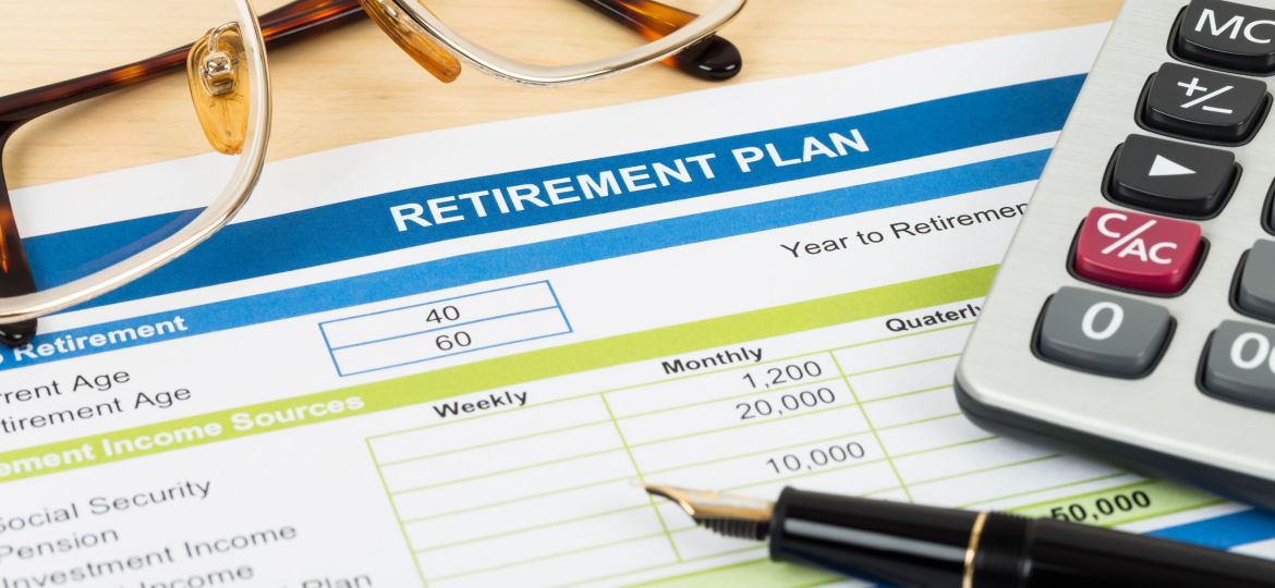 Retirement plan with glasses, pen, and calculator; document is mock-up