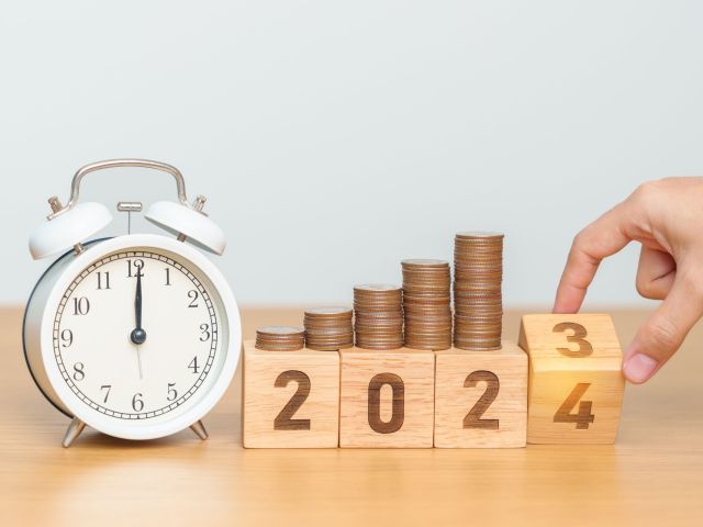 Happy New Year with vintage alarm clock and flipping 2023 change to 2024 block. Resolution, Goals, Plan, Action, Money Saving, Retirement fund, Pension, Investment and Financial concept