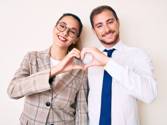 Business people making heart sign